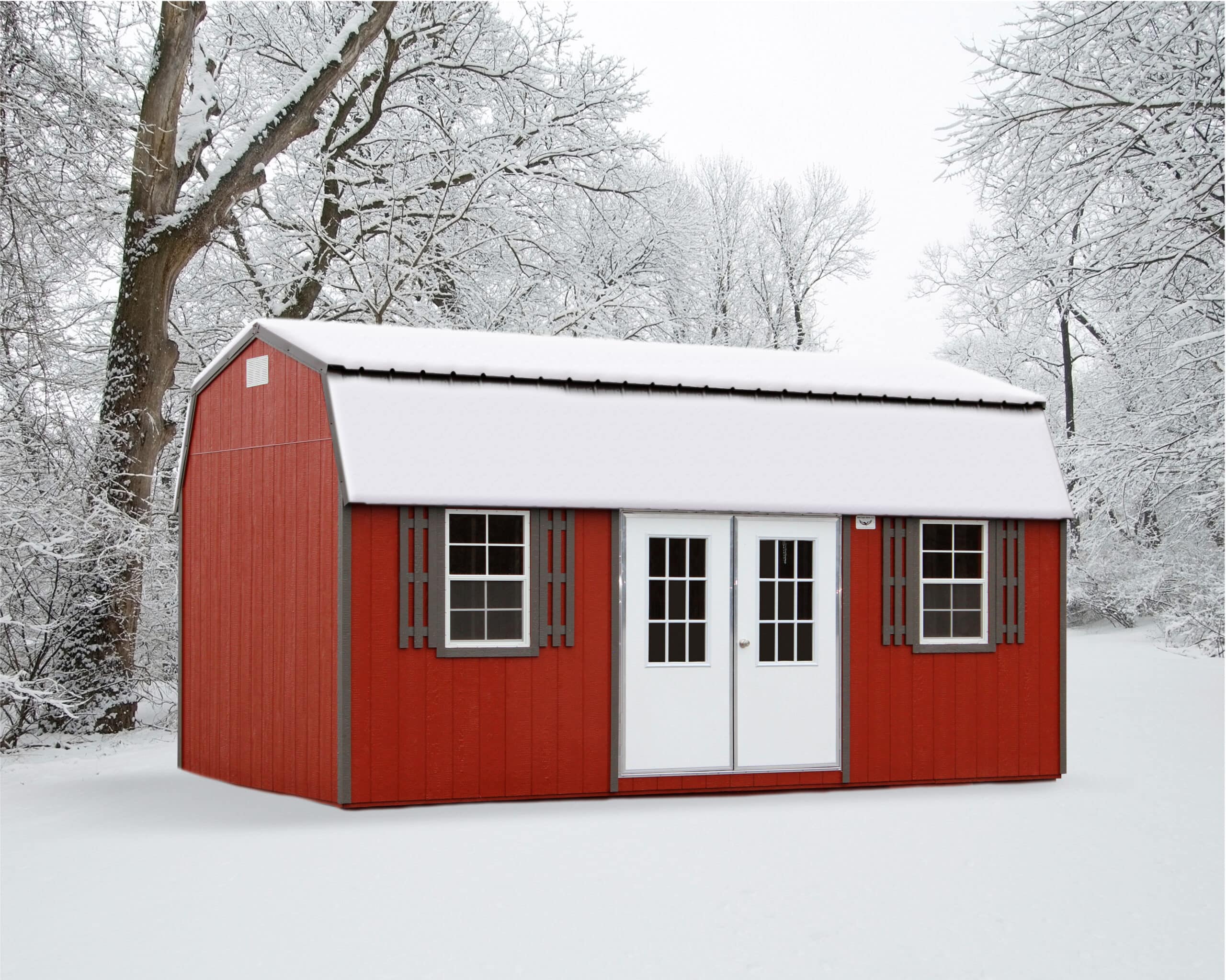 A vibrant 8x16 side lofted barn shed with a red-painted exterior and contrasting gray trim, set in a snowy winter landscape. The shed features a classic gambrel roof covered in a pristine layer of snow, adding to its rustic charm. Double white French doors in the center, flanked by two white-framed windows with decorative gray shutters, provide an inviting and functional design. Surrounded by snow-covered trees, the shed exudes a cozy, picturesque aesthetic perfect for winter storage or workspace needs.