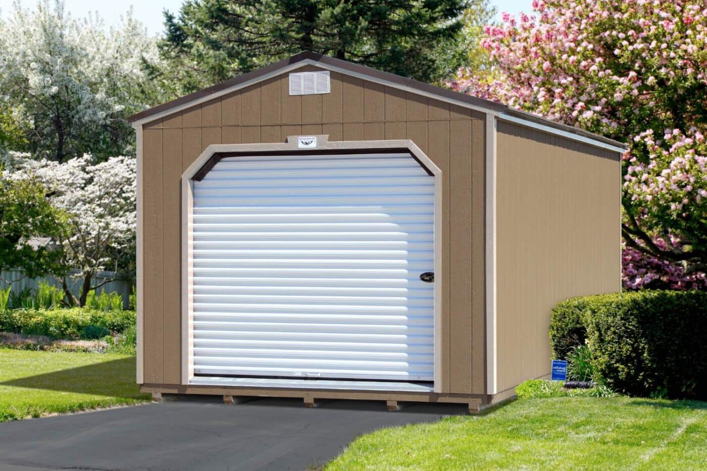 Brown shed with white garage door set on wooden foundation on concrete