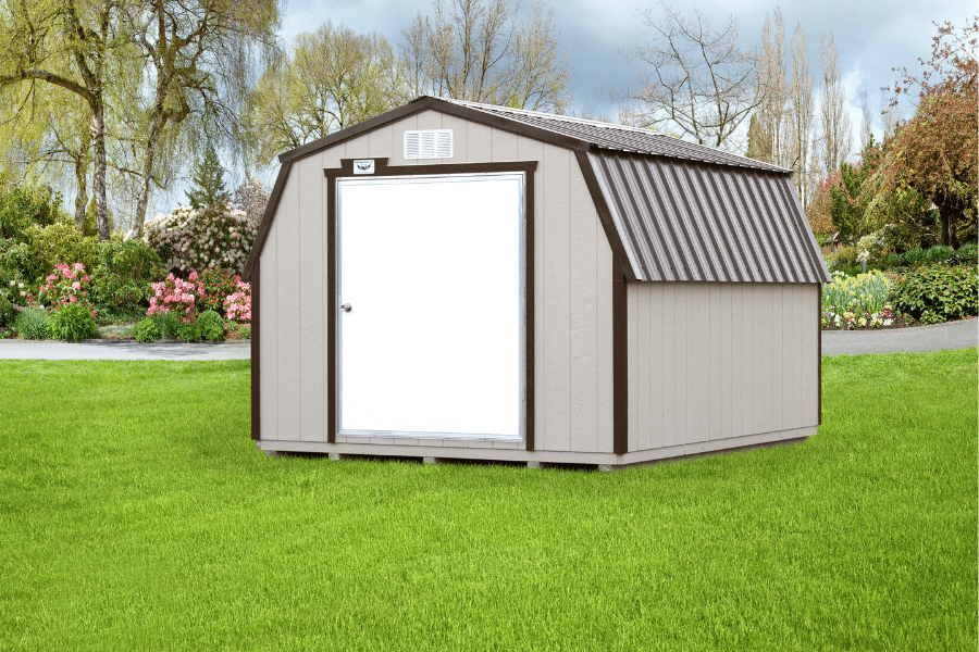 cream barn shed with dark brown trim and curved brown metal roof