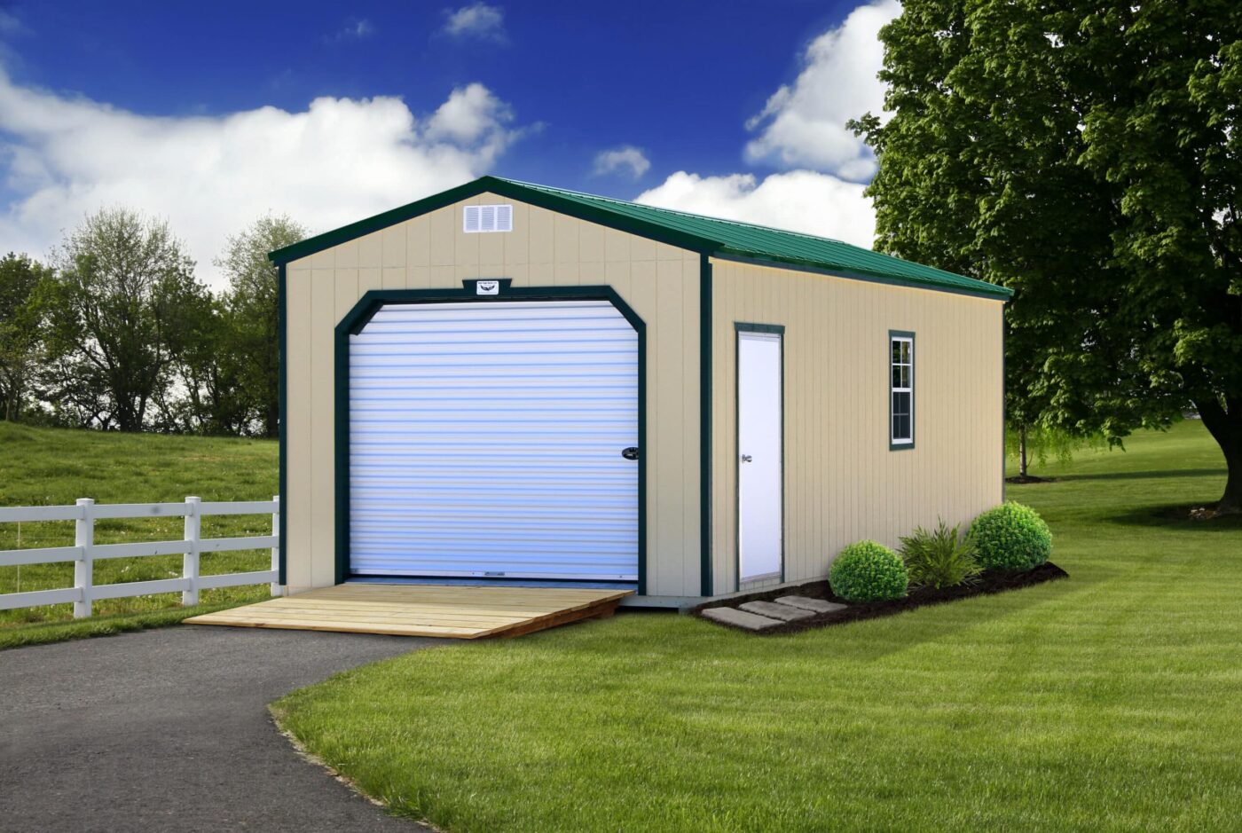 a beige portable garage shed with green trim, a green metal roof, and a ramp for sale in newport AR